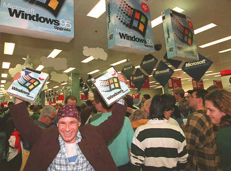 Mikol Furneaux(L) waves two packages of Windows 95