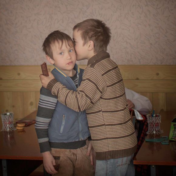 140324 Igor and his friend Renat has an intimate moment of friendship in the classroom. Igor celebrates his ninth birthday and their grandmother bought chocolate for the the boys and their friends. "I wish a pair of boxinggloves for my birthday, says Igor.” Igor also have a twinbrother and when they were only two years old their mother travelled to Moscow to work in the construction field. Three weeks later they found out that she died in a hemorrhage and they have no father. Thousands of children grow up without their parents in the Moldovan countryside. Some villages have turned into ghost towns. Young people have fled the country, leaving an dwindling, elderly population and young children. Schools are forced to close and whole villages are erased on the map. Some of them will never meet their parents again. For the children of Moldova, the future is uncertain.