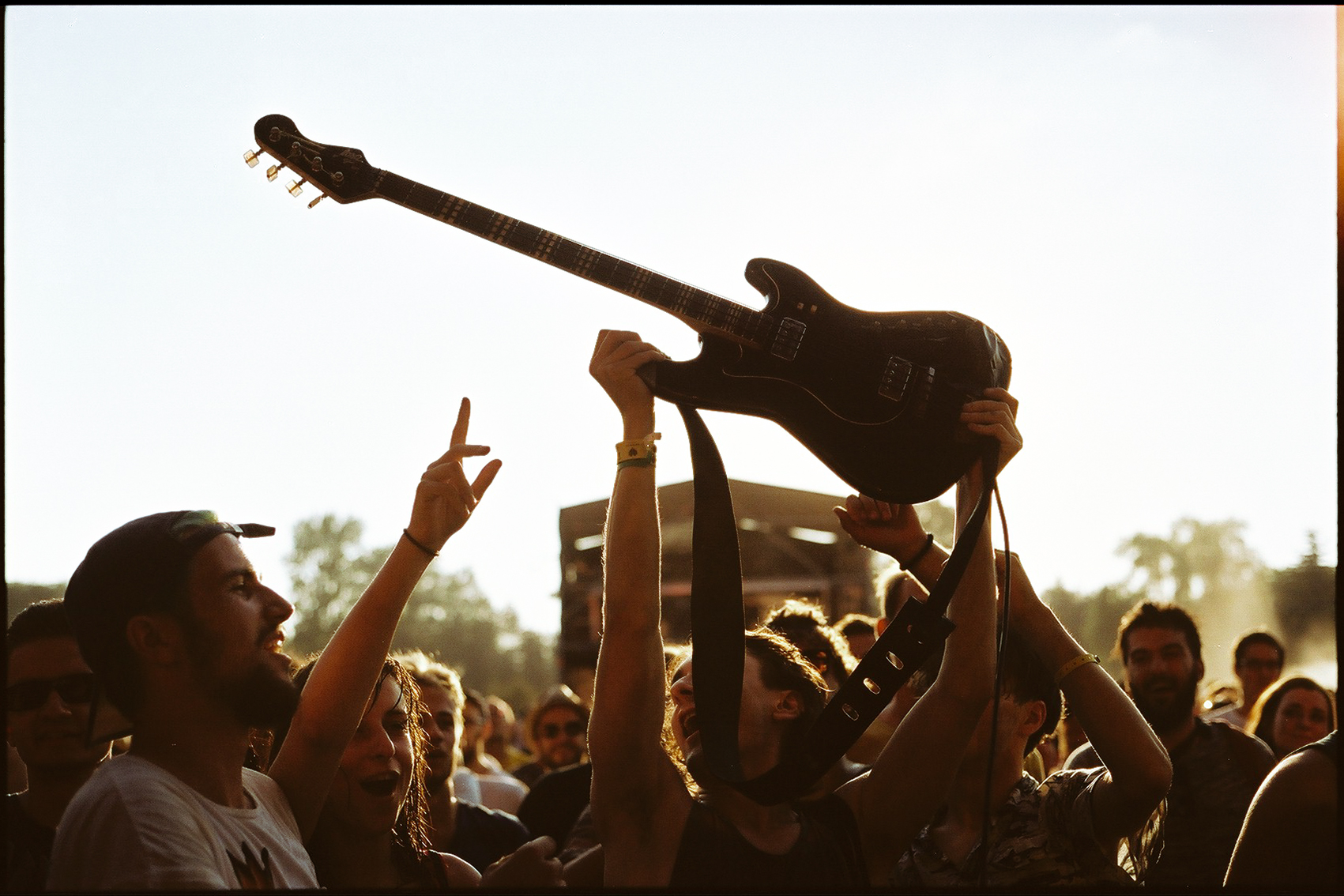 Ludzie pod sceną na koncercie trzymają gitarę
