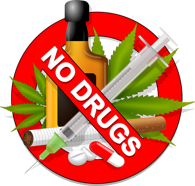 obrazek przedstawia butelkę, skrzykawkę, liście marihuany, papierosa i kilka pigułek. Wszystko to wpisane jest w grafikę czerwonego kółka z napisem "no drugs"