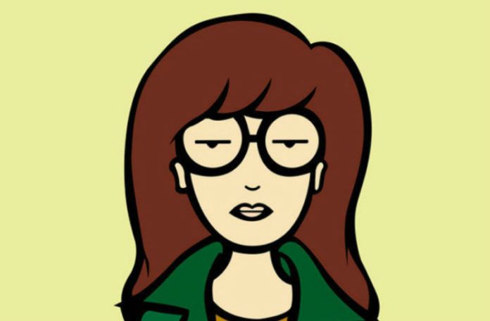 Grafika przedstawiająca brązowowłosą dziewczynę w okularach, zielonej marynarce i musztardowej koszulce