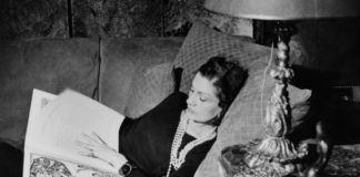 Kobieta leżąca na łóżku przeglądająca książkę