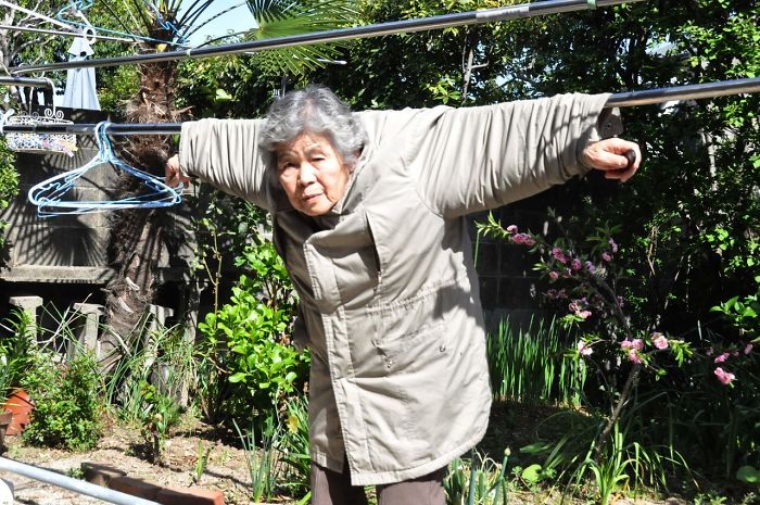 Starsza kobieta wisząca na sznurki od prania