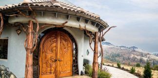 Dom z dużymi, rzeźbionymi drewnianymi drzwiami