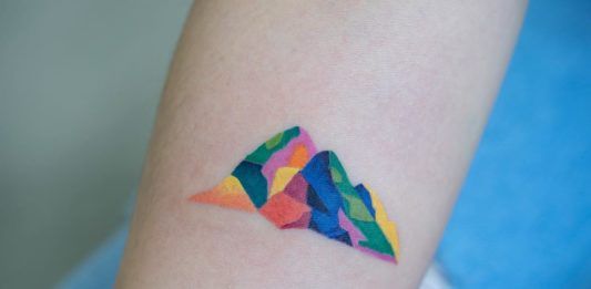 Kolorowy tatuaż przedstawiający góry